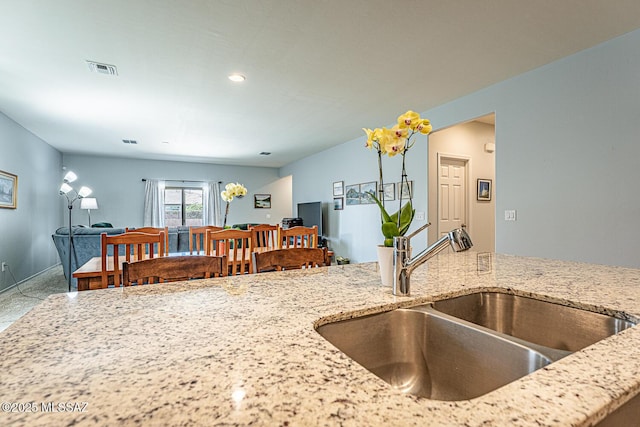 12625 N Wildrose Dr, Marana, AZ 85653 - kitchen with a sink, light stone countertops, recessed lighting, and baseboards