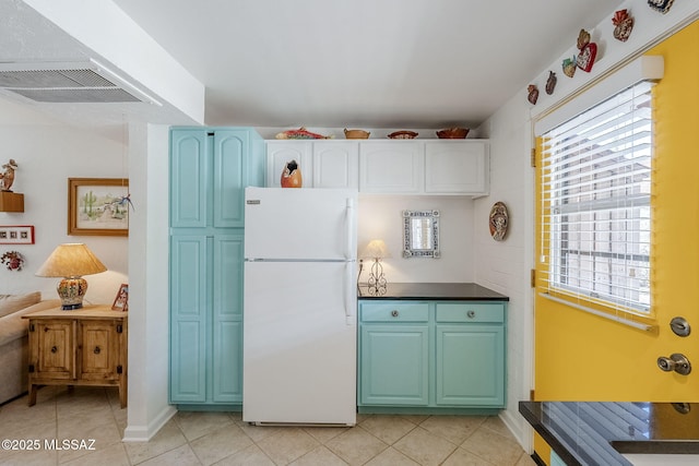 344 S Paseo Sarta Unit C, Green Valley, AZ 85614 - kitchen featuring freestanding refrigerator, light tile patterned flooring, plenty of natural light, and dark countertops