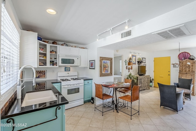 344 S Paseo Sarta Unit C, Green Valley, AZ 85614 - kitchen with white appliances, a sink, dark countertops, healthy amount of natural light, and recessed lighting
