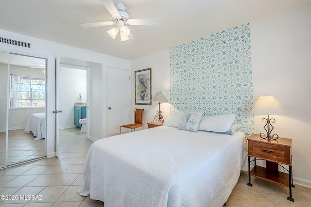 344 S Paseo Sarta Unit C, Green Valley, AZ 85614 - bedroom with light tile patterned floors, baseboards, a ceiling fan, and connected bathroom