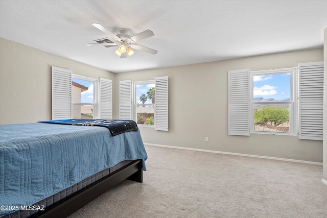 10095 N Mill Crossing Way, Tucson, AZ 85743 - carpeted bedroom with baseboards and a ceiling fan