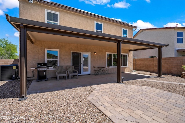 10095 N Mill Crossing Way, Tucson, AZ 85743 - rear view of property featuring stucco siding, a patio area, and cooling unit
