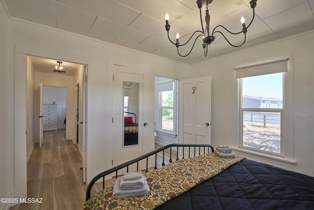 203 N Kellum Ave, Bowie, AZ 85605 - bedroom featuring wood finished floors, a chandelier, and crown molding
