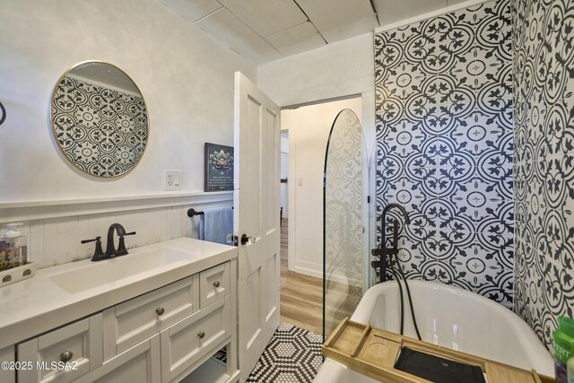 203 N Kellum Ave, Bowie, AZ 85605 - full bathroom featuring a bathtub, vanity, and wood finished floors