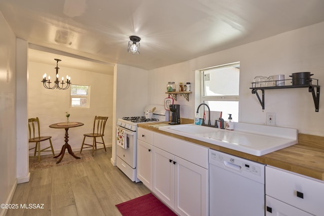 203 N Kellum Ave, Bowie, AZ 85605 - kitchen featuring white appliances, light wood finished floors, white cabinets, open shelves, and a sink