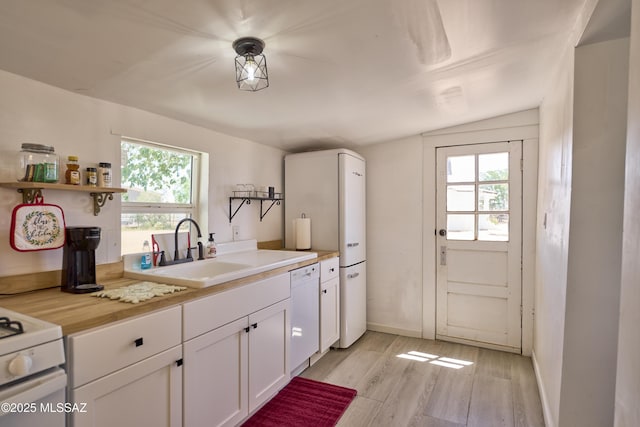 203 N Kellum Ave, Bowie, AZ 85605 - kitchen featuring white appliances, a sink, open shelves, light wood-style flooring, and light countertops
