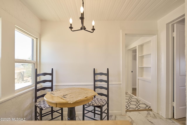 203 N Kellum Ave, Bowie, AZ 85605 - dining space featuring a chandelier, light marble finish floors, and wooden ceiling
