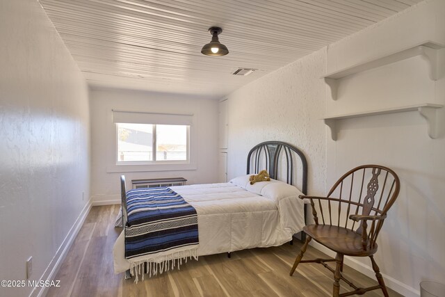 203 N Kellum Ave, Bowie, AZ 85605 - bedroom with wood finished floors and baseboards