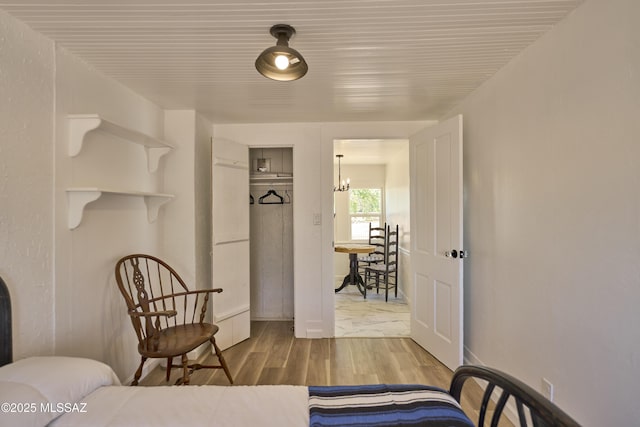 203 N Kellum Ave, Bowie, AZ 85605 - bedroom featuring a chandelier and wood finished floors
