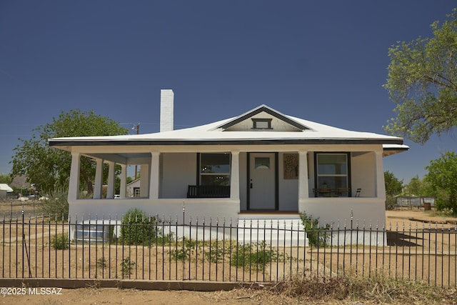 203 N Kellum Ave, Bowie, AZ 85605 - bungalow-style home with covered porch, a fenced front yard, a chimney, and stucco siding