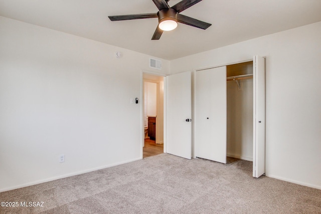 unfurnished bedroom with carpet, a closet, ceiling fan, and baseboards