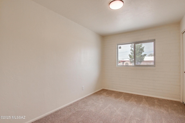 carpeted spare room with baseboards