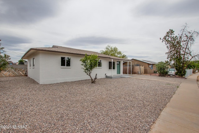 ranch-style home with fence