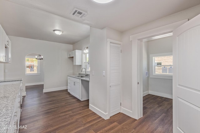 2956 N Tyndall Ave, Tucson, AZ 85719 - kitchen featuring a sink, dark wood-type flooring, baseboards, and white cabinetry