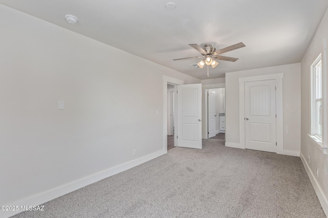 2956 N Tyndall Ave, Tucson, AZ 85719 - unfurnished bedroom with light carpet, baseboards, and ceiling fan