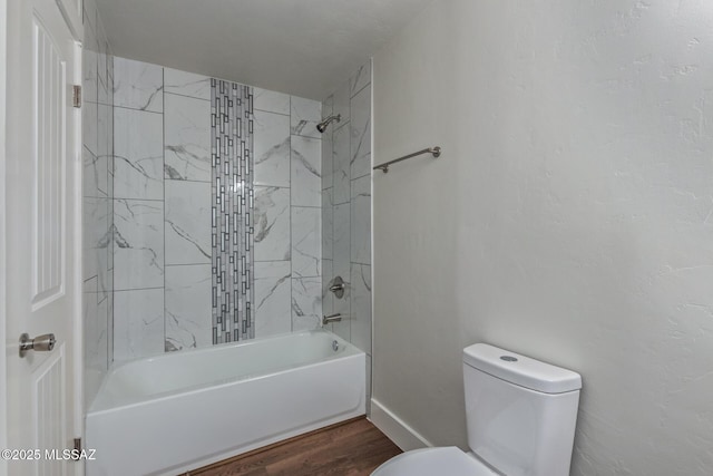 2956 N Tyndall Ave, Tucson, AZ 85719 - full bath with toilet, shower / bath combination, wood finished floors, and baseboards