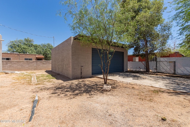 2956 N Tyndall Ave, Tucson, AZ 85719 - view of outdoor structure with fence, a garage, an outdoor structure, and driveway