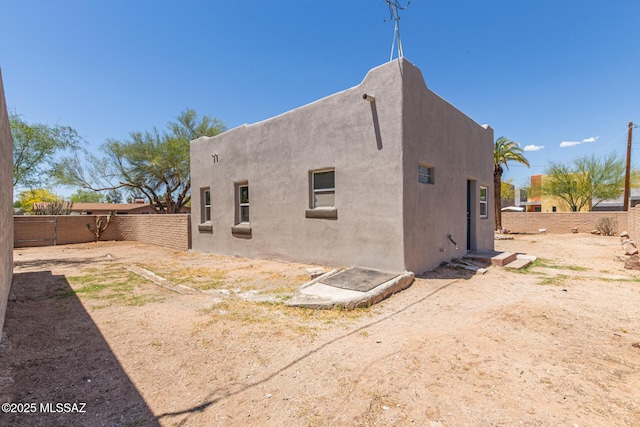 2956 N Tyndall Ave, Tucson, AZ 85719 - rear view of property with a fenced backyard and stucco siding
