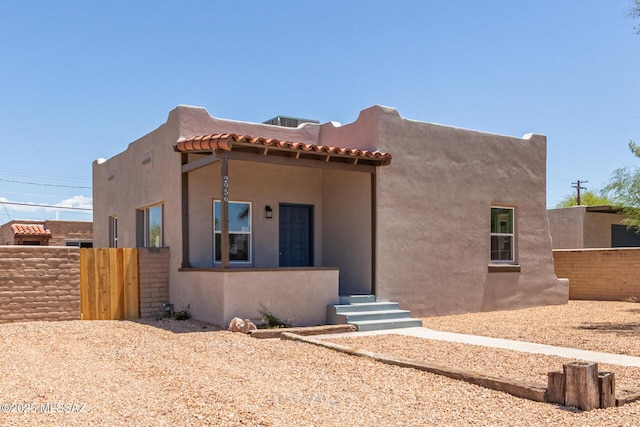 2956 N Tyndall Ave, Tucson, AZ 85719 - pueblo-style home featuring fence, stucco siding, and a tiled roof