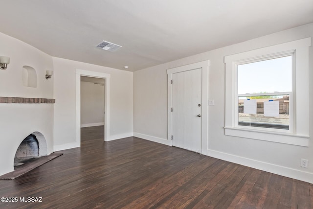 2956 N Tyndall Ave, Tucson, AZ 85719 - unfurnished living room featuring dark wood-style flooring and baseboards