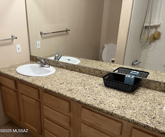 bathroom featuring vanity, toilet, and a shower