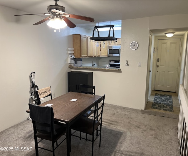 dining room featuring a ceiling fan and carpet floors