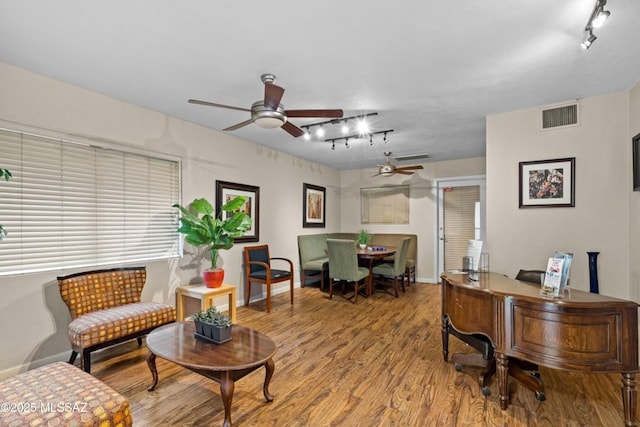 office with track lighting, a ceiling fan, wood finished floors, and baseboards