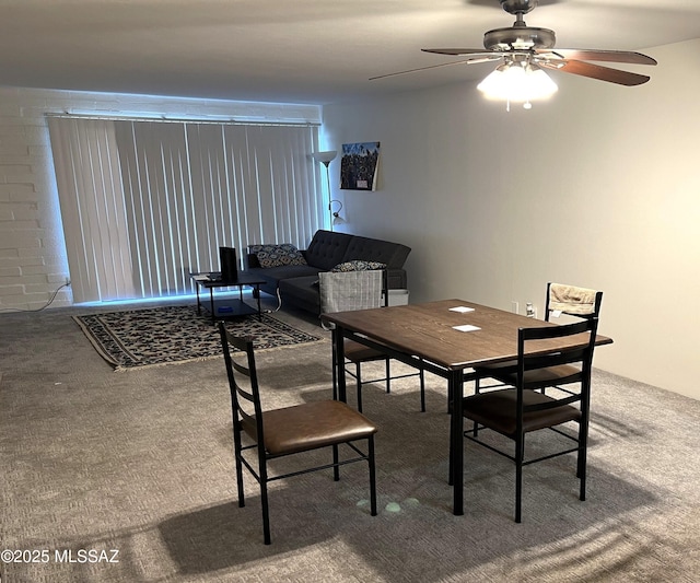 dining room with a ceiling fan and carpet flooring