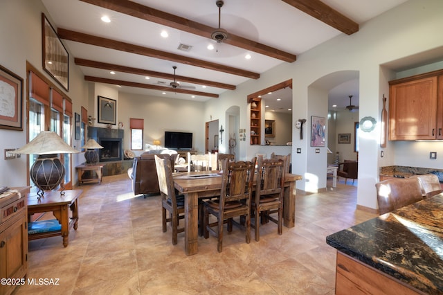 12800 W Arivaca Rd, Amado, AZ 85645 - dining area with a ceiling fan, arched walkways, beam ceiling, and recessed lighting