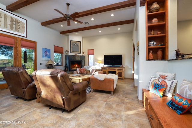 12800 W Arivaca Rd, Amado, AZ 85645 - living area with beam ceiling, a lit fireplace, recessed lighting, a ceiling fan, and light stone finish floors