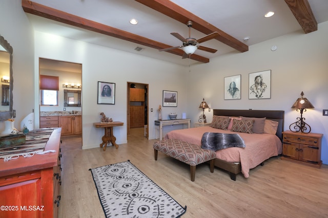 12800 W Arivaca Rd, Amado, AZ 85645 - bedroom featuring beamed ceiling, light wood-style flooring, connected bathroom, and recessed lighting