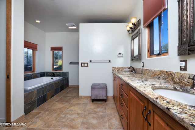 12800 W Arivaca Rd, Amado, AZ 85645 - bathroom with double vanity, tiled bath, stone finish flooring, and baseboards
