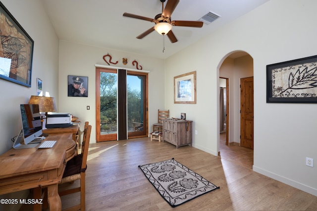 12800 W Arivaca Rd, Amado, AZ 85645 - office area with arched walkways, a ceiling fan, light wood finished floors, and baseboards