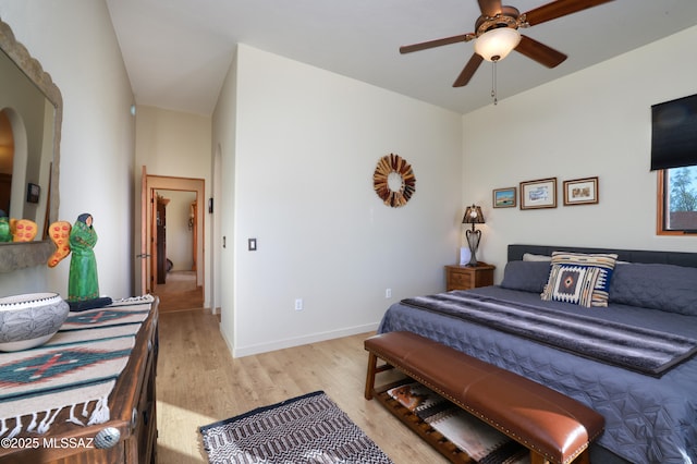 12800 W Arivaca Rd, Amado, AZ 85645 - bedroom featuring light wood-style floors, arched walkways, baseboards, and a ceiling fan