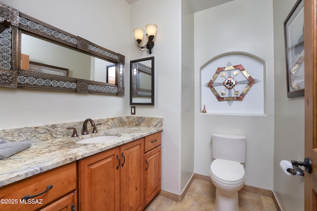 12800 W Arivaca Rd, Amado, AZ 85645 - bathroom with vanity, toilet, baseboards, and tile patterned flooring