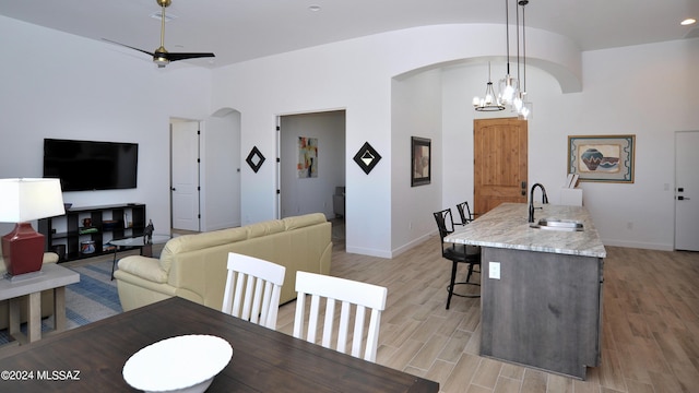 432 N Heritage Point Pl, Sahuarita, AZ 85629 - dining area with arched walkways, baseboards, and light wood-style flooring