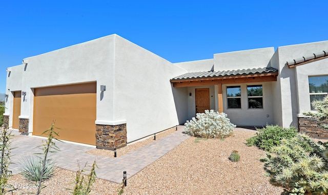 432 N Heritage Point Pl, Sahuarita, AZ 85629 - southwest-style home with stucco siding, an attached garage, a tiled roof, and stone siding