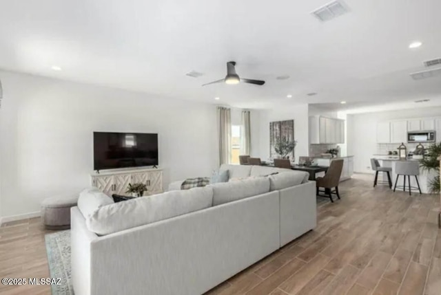 12734 E Russo Dr, Vail, AZ 85641 - living area featuring light wood-style flooring, recessed lighting, a ceiling fan, and baseboards