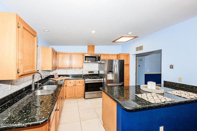 2607 E Adams St, Tucson, AZ 85716 - kitchen featuring appliances with stainless steel finishes, a sink, tasteful backsplash, dark stone counters, and recessed lighting