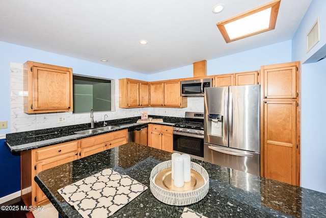 2607 E Adams St, Tucson, AZ 85716 - kitchen with appliances with stainless steel finishes, a sink, backsplash, dark stone countertops, and recessed lighting