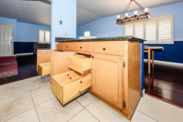 2607 E Adams St, Tucson, AZ 85716 - kitchen featuring lofted ceiling, a chandelier, light brown cabinetry, dark stone countertops, and baseboards