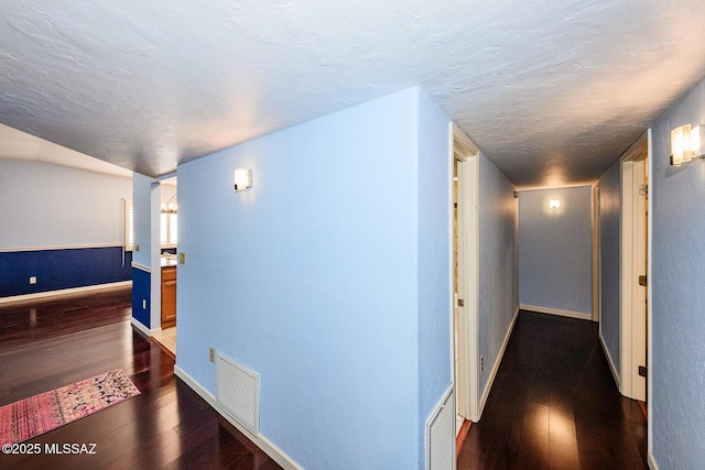 2607 E Adams St, Tucson, AZ 85716 - hallway with dark wood-style floors, baseboards, and a textured ceiling