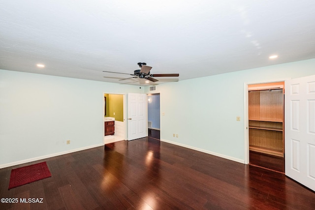 2607 E Adams St, Tucson, AZ 85716 - unfurnished bedroom featuring a spacious closet, dark wood-type flooring, baseboards, recessed lighting, and ensuite bathroom