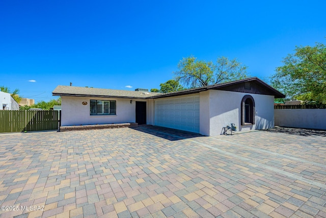 2607 E Adams St, Tucson, AZ 85716 - ranch-style home with stucco siding, an attached garage, fence, and driveway