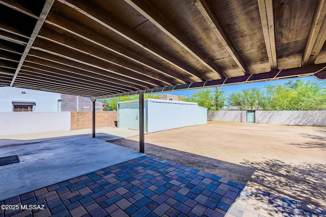2607 E Adams St, Tucson, AZ 85716 - view of patio featuring a fenced backyard and an outbuilding