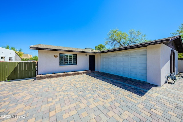 2607 E Adams St, Tucson, AZ 85716 - view of front of property with stucco siding, an attached garage, fence, and driveway