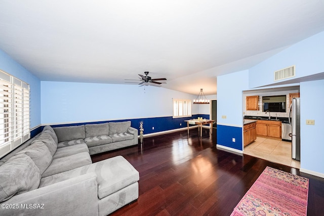 2607 E Adams St, Tucson, AZ 85716 - living room featuring lofted ceiling, light wood finished floors, ceiling fan, and baseboards