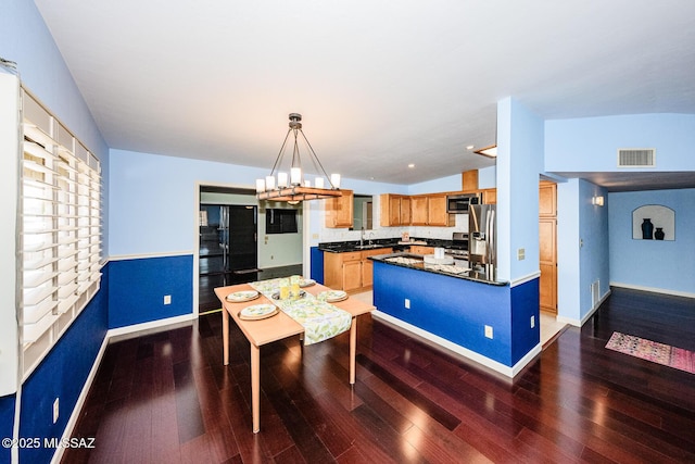 2607 E Adams St, Tucson, AZ 85716 - dining space featuring wood finished floors, a chandelier, and baseboards