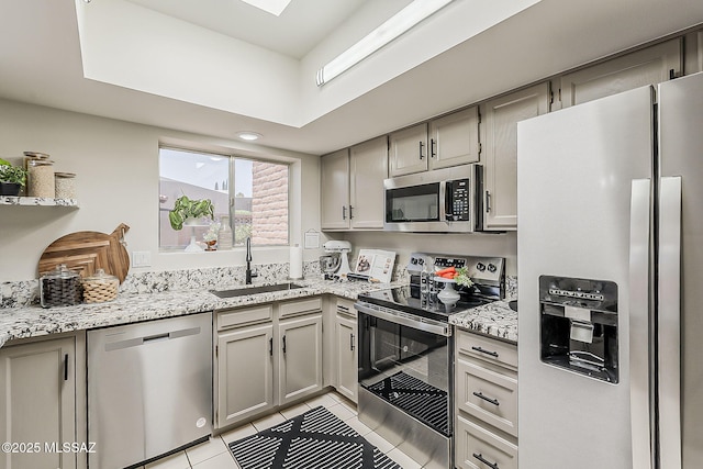 2756 S Via Del Bac, Green Valley, AZ 85622 - kitchen featuring appliances with stainless steel finishes, a sink, light tile patterned floors, light stone countertops, and gray cabinetry