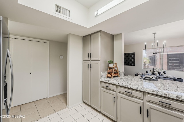 2756 S Via Del Bac, Green Valley, AZ 85622 - kitchen with stainless steel refrigerator with ice dispenser, a chandelier, light tile patterned floors, decorative light fixtures, and baseboards